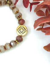 Load image into Gallery viewer, Crystal And Gold Stretch Bracelet With A Celtic Charm