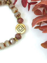 Load image into Gallery viewer, Crystal And Gold Stretch Bracelet With A Celtic Charm
