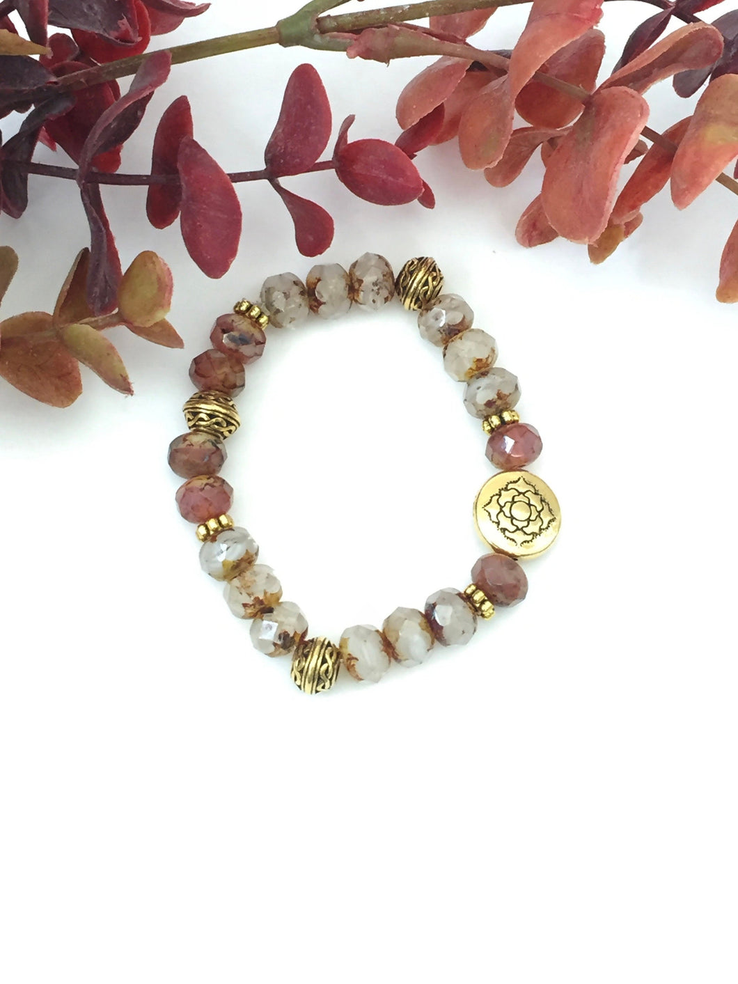 Crystal And Gold Stretch Bracelet With A Celtic Charm